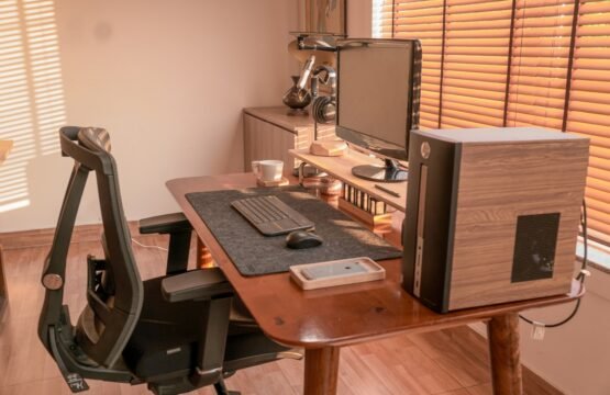 a computer desk with a monitor, keyboard and mouse
