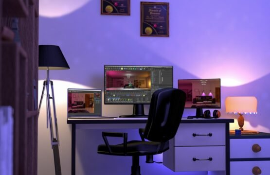 a computer desk with two monitors and a lamp